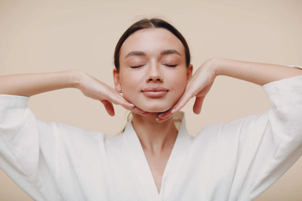 young woman doing face building yoga facial gymnastics self massage rejuvenating exercises 1